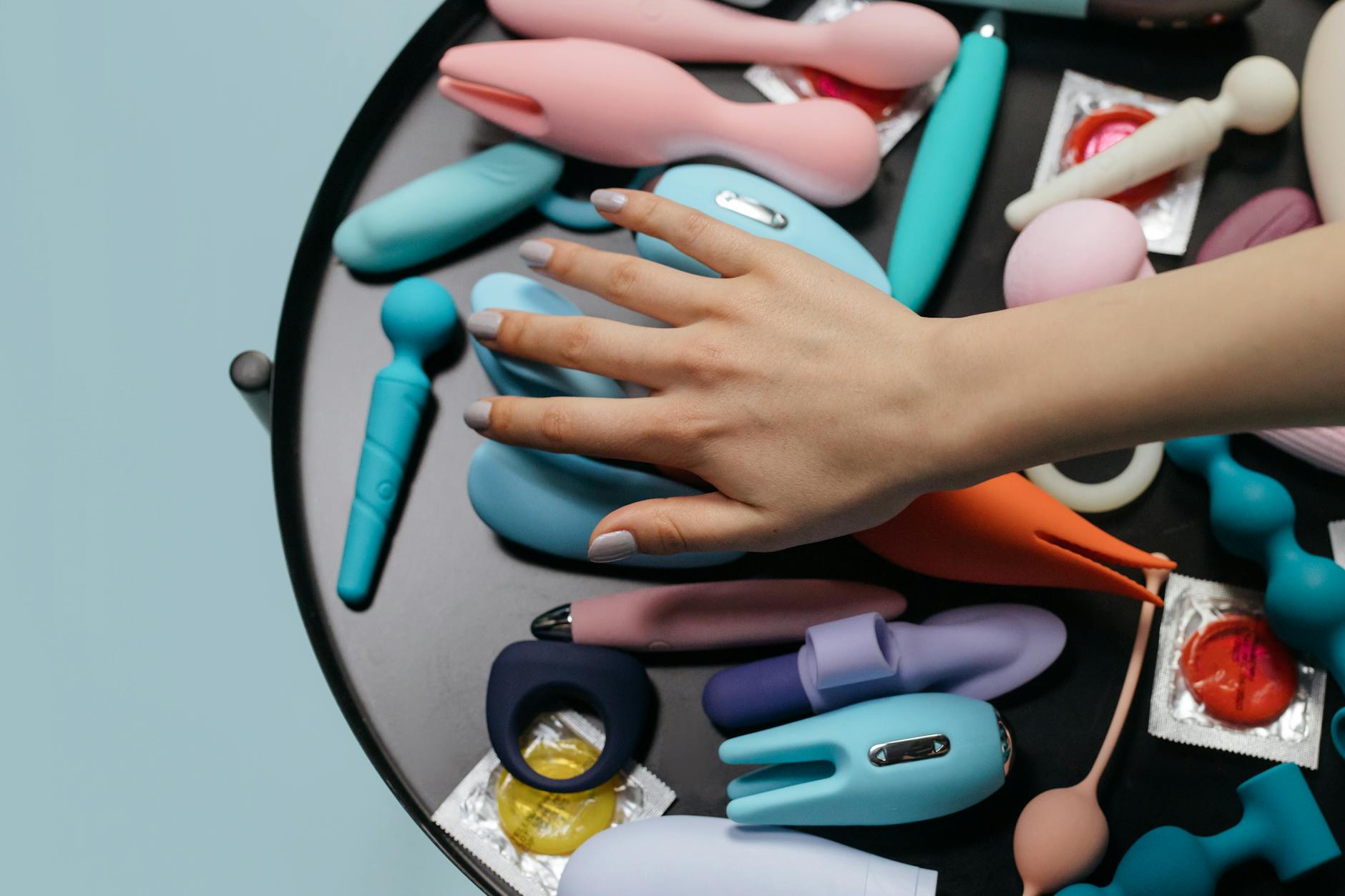 Colorful vibrators arranged on a table, highlighting options for pleasure when medication affects sensation