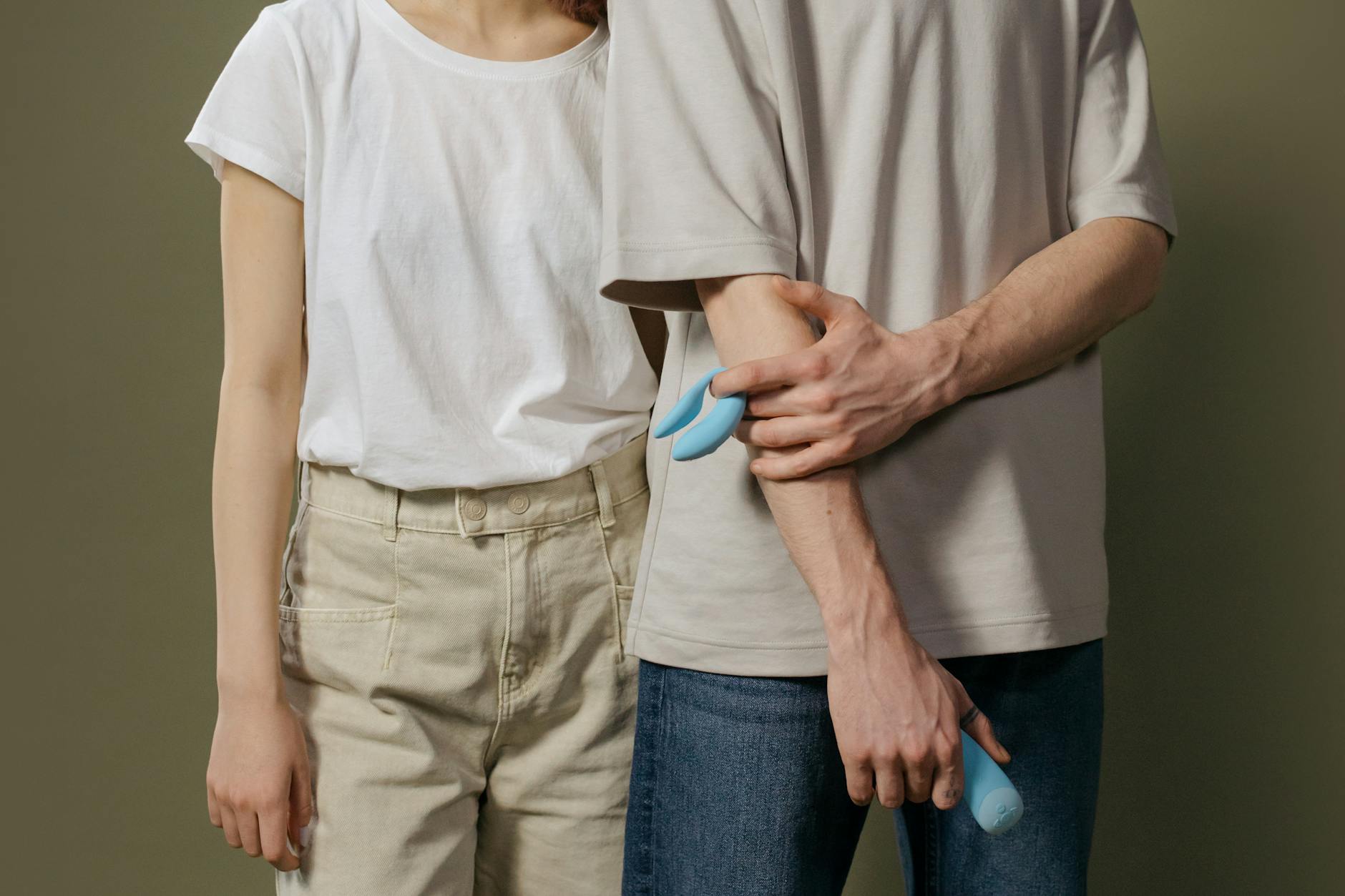 A couple holding a vibrator together, representing rebuilding intimacy and trust through shared exploration