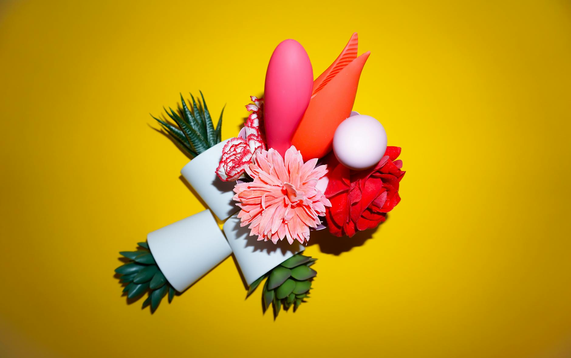 Close-up of hands holding a lemon clitoral vibrator against a knitted sweater