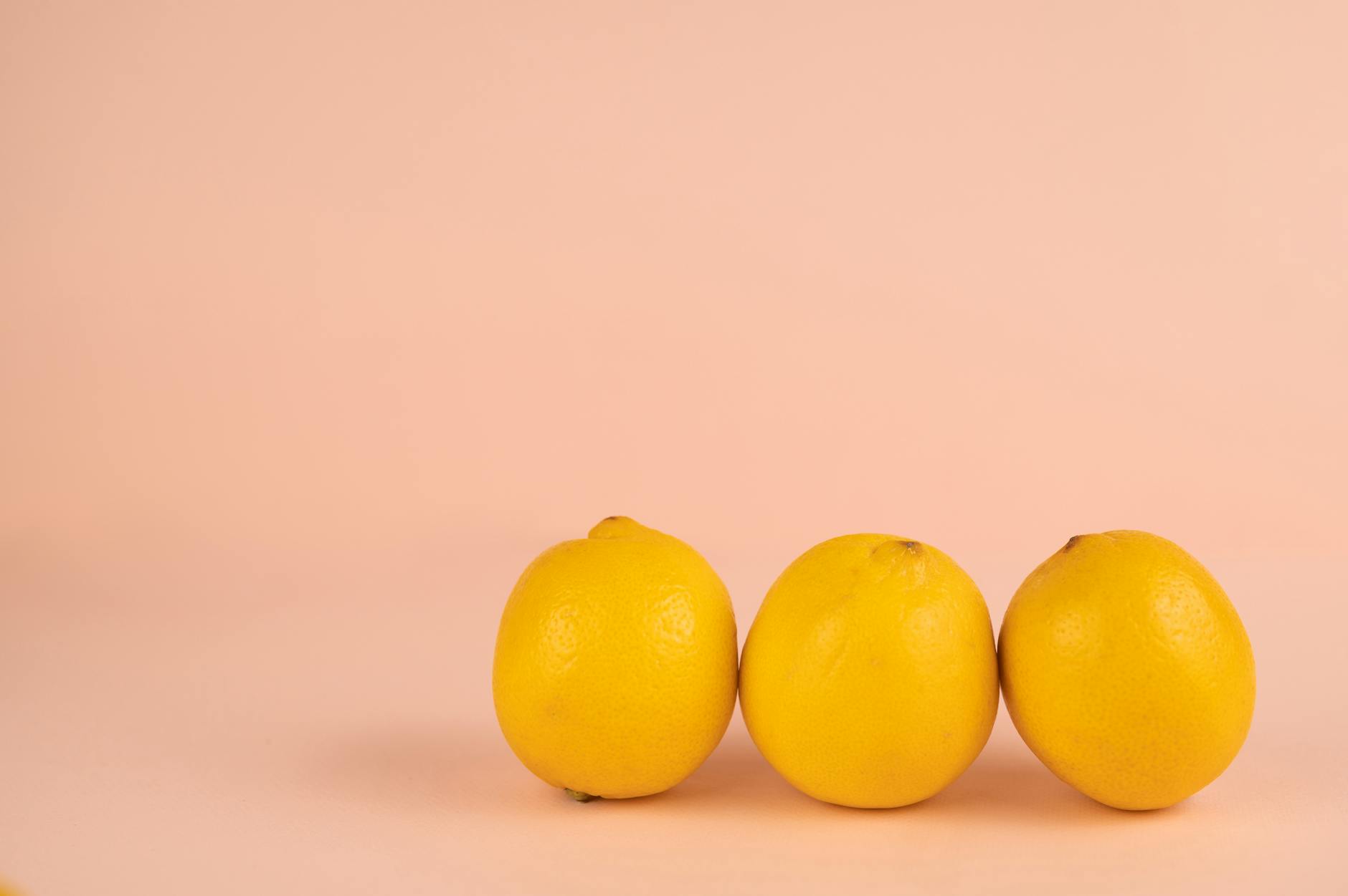 Bright ripe lemons arranged on a pastel background, symbolizing natural pleasure and renewal